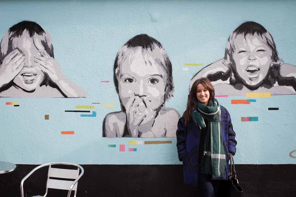 Oihane smiles in front of a painted wall, in Waterford.