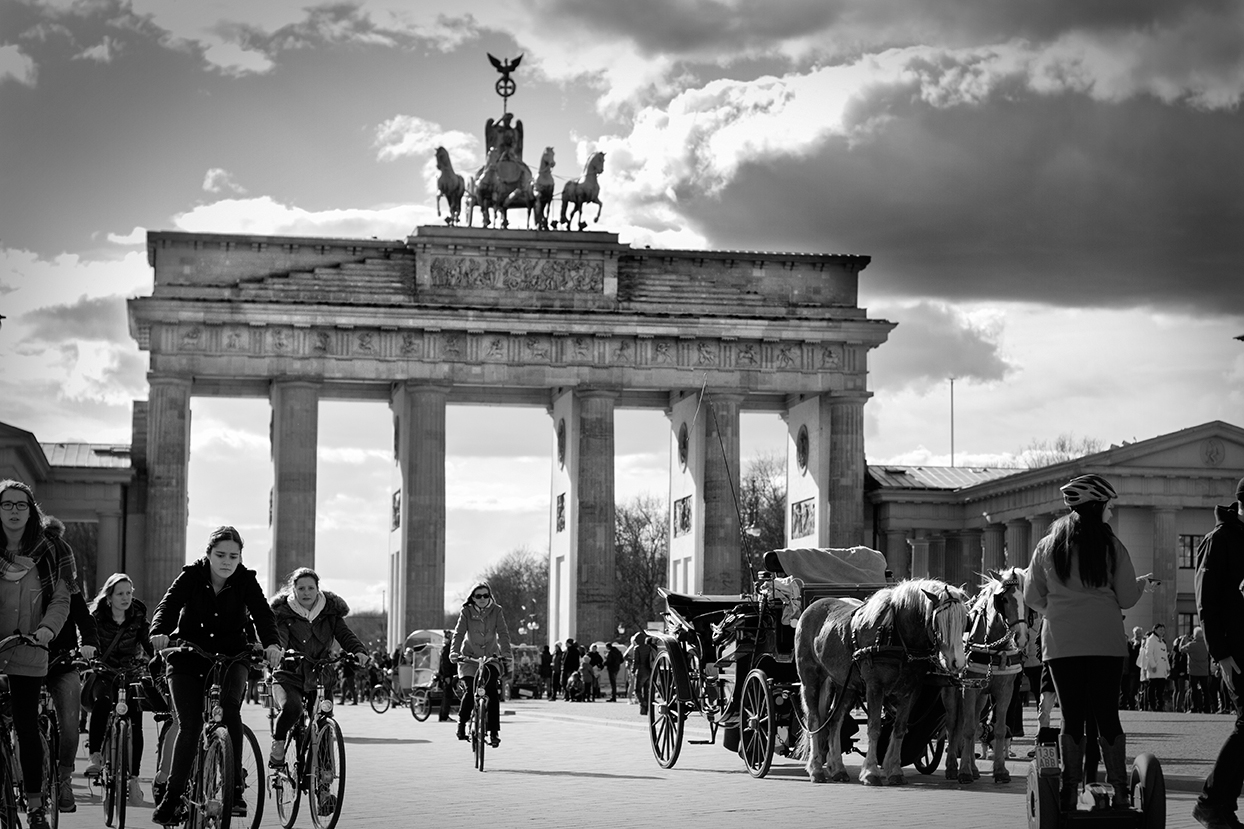 A group of tourists ride along one of the most visited areas of the city: the Brandenburger Tor.